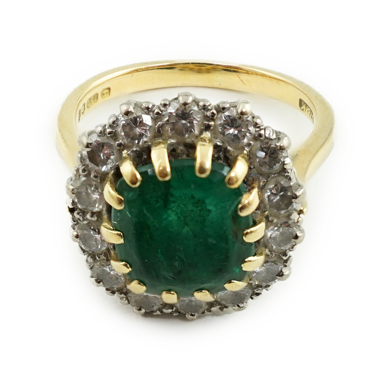 A late 1970's 18ct gold, emerald and diamond set oval cluster ring